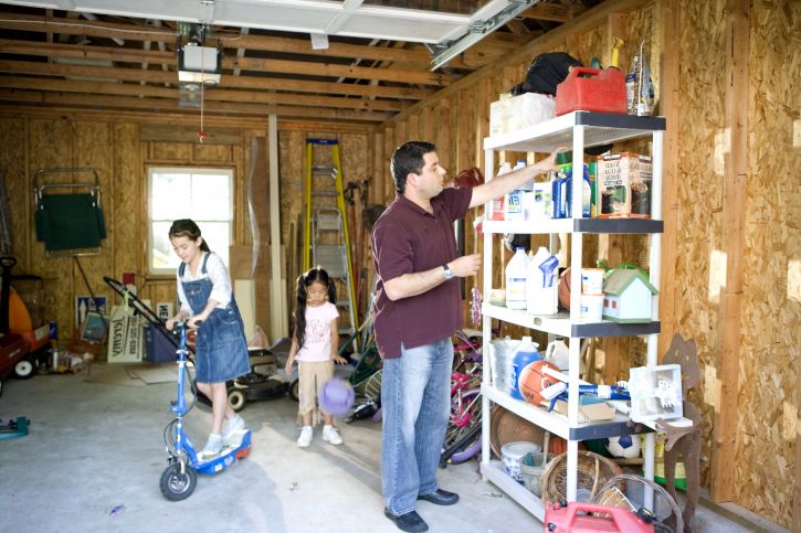 children-playing-in-garage-while-father-working-725x483