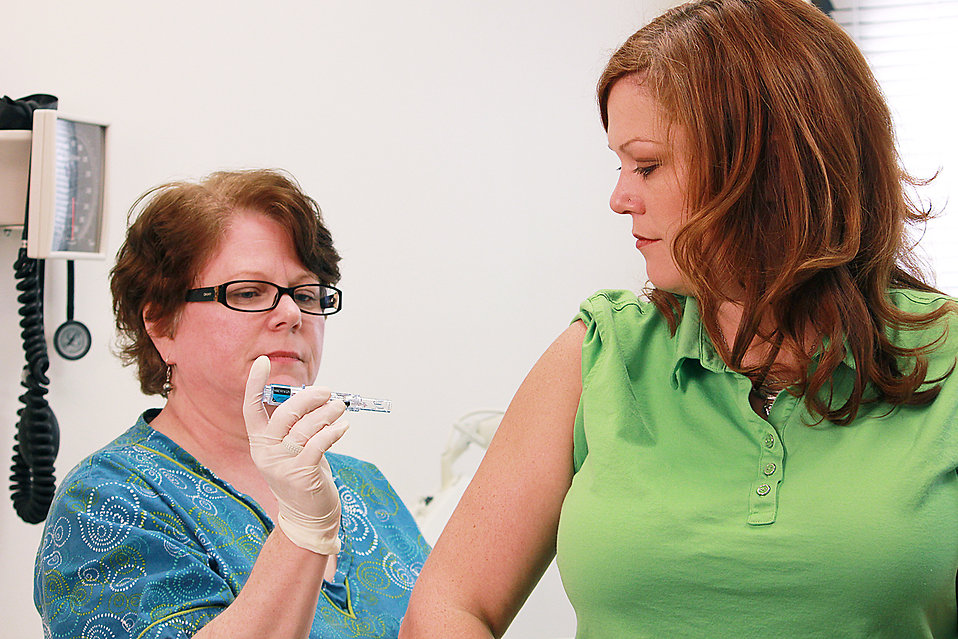 17096-a-nurse-giving-a-woman-a-flu-vaccine-shot-pv