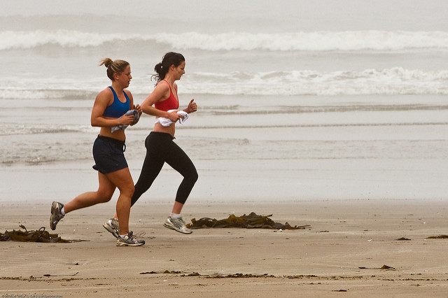 Two female joggers on foggy Morro Strand State Beach, seen during a Digital Photo Walk http://photomorrobay.com/walks/ led by Mike Baird,  17 May 2009.   Eighteen participants enhanced their basic camera and photography skills on this foggy morning outing.  Photo by Michael 